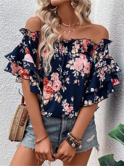 Blusa floreale con spalle scoperte