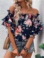 Blusa floreale con spalle scoperte